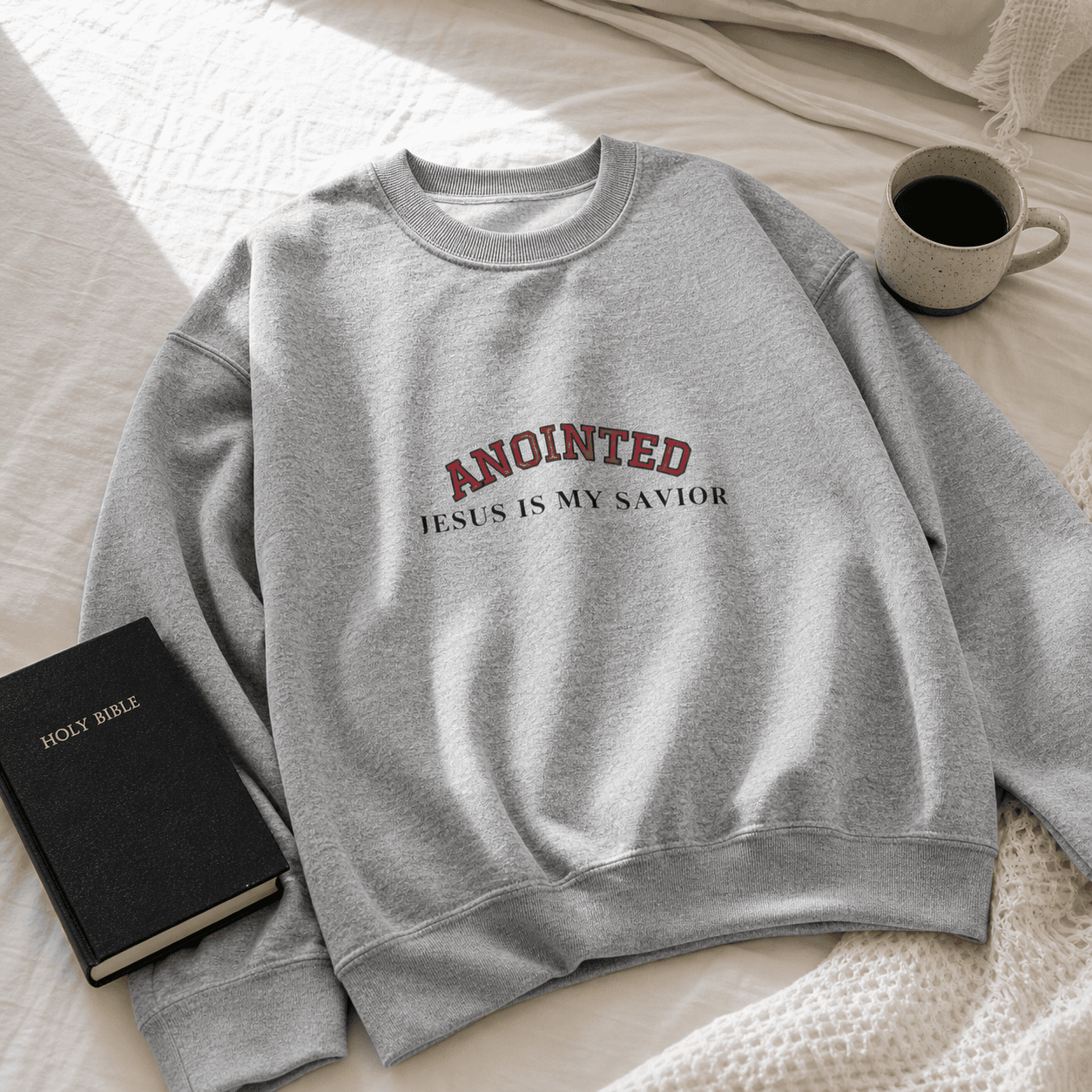 Gray My Jesus sweatshirt laid flat next to a Bible and coffee
